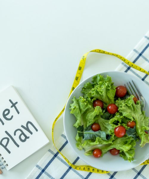 Diet planning or diet control Program and tape measure mannequins program. weight loss diets choosing to eat fresh fruit and vegetable salad. Diet planning and Detox concept