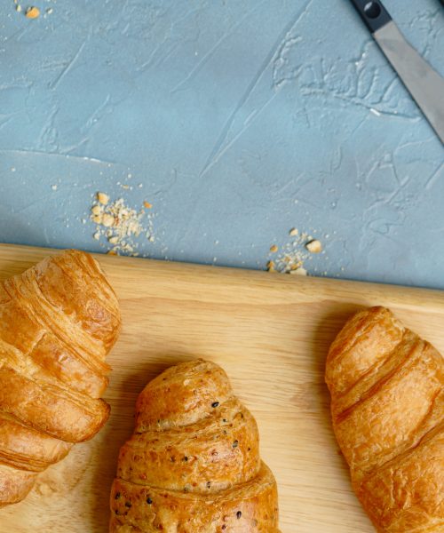 freshly baked croissants on black plate. French and American Croissants and Baked Pastries are enjoyed world wide.