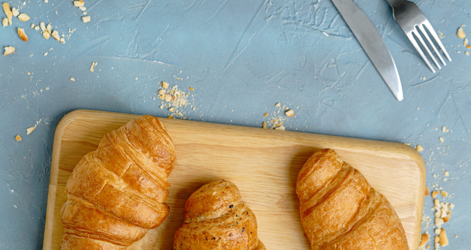 freshly baked croissants on black plate. French and American Croissants and Baked Pastries are enjoyed world wide.